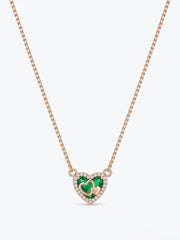 A rose gold box chain necklace featuring a heart-shaped pendant with a green heart in the center, surrounded by a halo of small clear stones and a tiny gold heart.